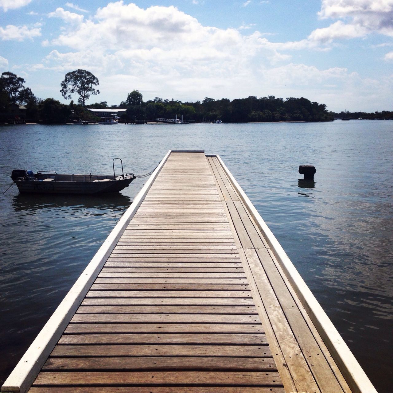 water, pier, sky, lake, tranquil scene, tranquility, the way forward, transportation, jetty, cloud - sky, wood - material, nautical vessel, nature, scenics, cloud, rippled, beauty in nature, boat, wood, river