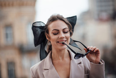 Portrait of beautiful woman holding umbrella