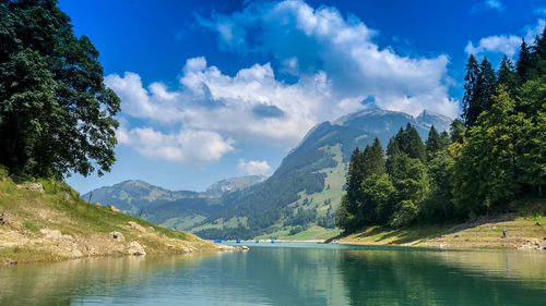 Scenic view of lake and mountains against sky