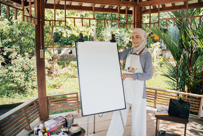 Portrait of young woman using digital tablet