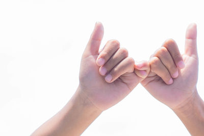 Close-up of woman hand over white background