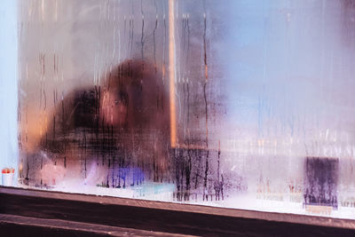 Reflection of woman on glass window