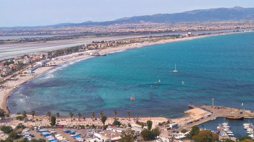 High angle view of sea and mountains against sky