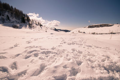 Scenic view of snow covered mountains against sky