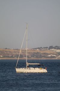 Yacht on tagus river against clear sky