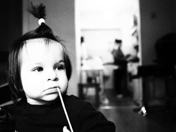 Close-up of girl carrying string in mouth