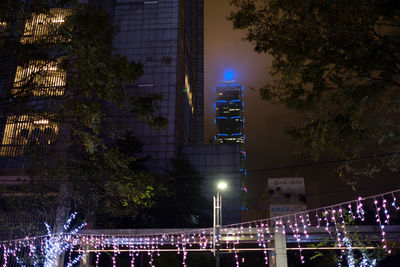 Illuminated city against sky at night