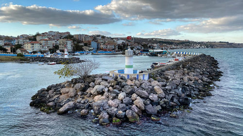 Scenic view of sea by city against sky