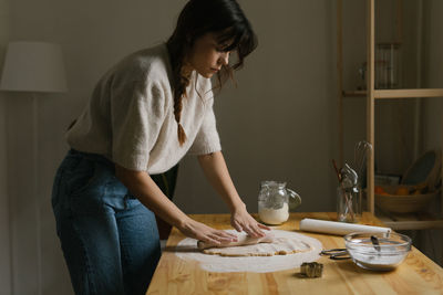 Young woman making christmas cookies