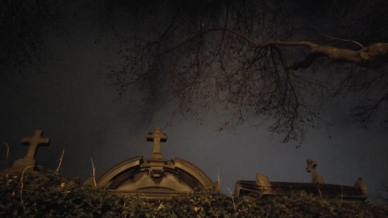 The Cemetery. · Paris France Cemetery Photography graves gravestone Cross Trees behind the wall moon light lighting Night Lights night sky Night Photography Darkness eery spooky Unedited unfiltered