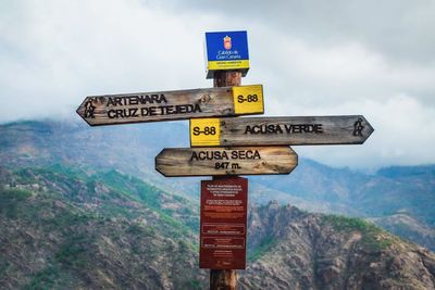 Information sign against sky