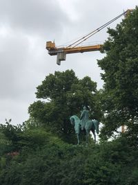 Low angle view of statue against sky