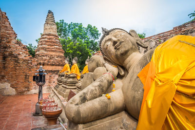 Buddha statue against historic building