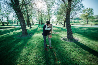 Man standing on field against trees