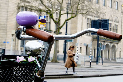 Bicycle parked on street against building