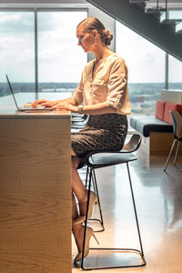 Woman working on table at home