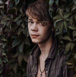 Portrait of boy standing by plants