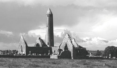 Traditional windmill on field against sky