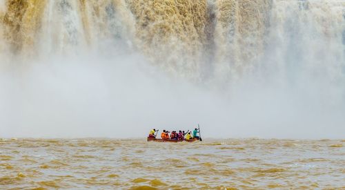 People in boat on river