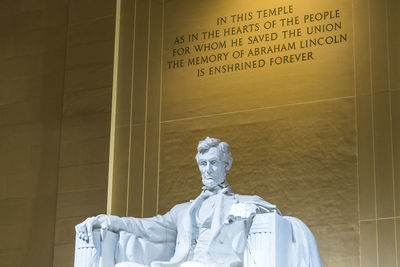 Low angle view of statue against wall