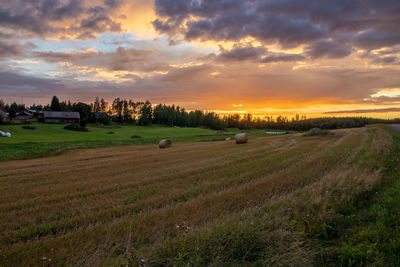 Scenic view of field against sky during sunset