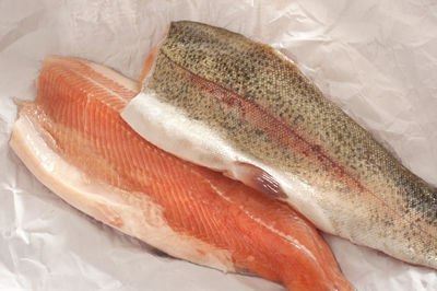 High angle view of rainbow trout fillets on paper