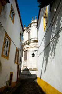 Low angle view of alley amidst buildings in city