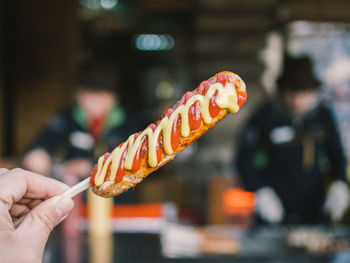 Close-up of hand holding sausage