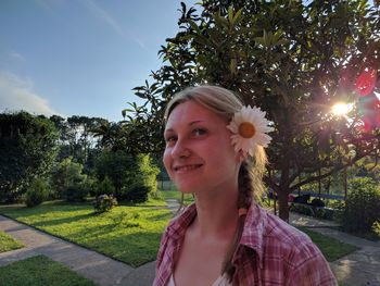 Portrait of smiling woman against plants