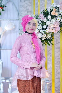 One of the beautiful bridesmaids in a pink kebaya