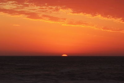 Scenic view of sea against romantic sky at sunset
