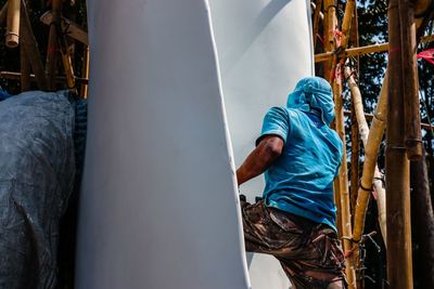 Rear view of man working at construction site