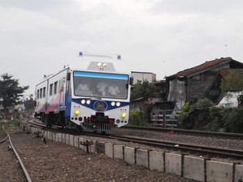 Train on railroad track against sky