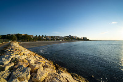 Scenic view of sea against clear blue sky