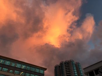 Low angle view of buildings against sky during sunset