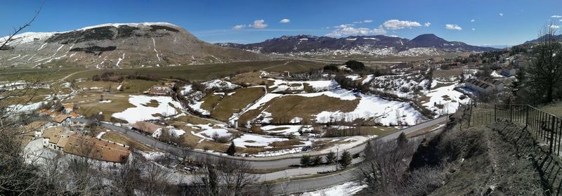 Aerial view of snowcapped mountains against sky