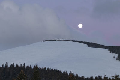 Scenic view of snowcapped mountains against sky during sunrise