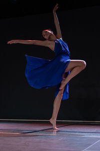 Low section of woman exercising on stage