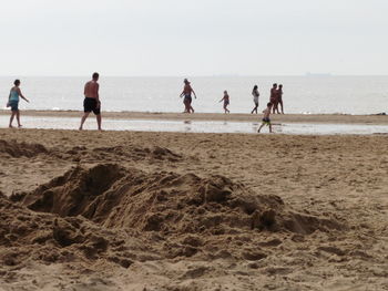 People enjoying sandy beach