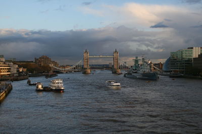 Boats in river with city in background