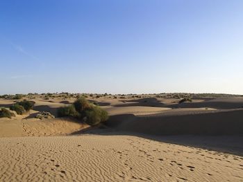 Scenic view of desert against clear sky