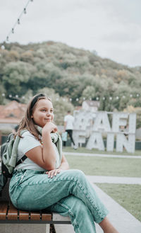 Young woman sitting on bench