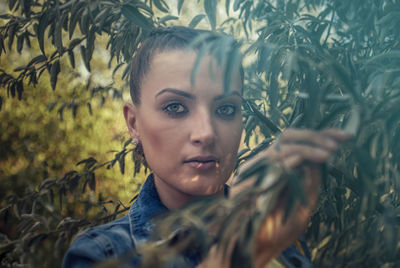 Portrait of young woman lying on field