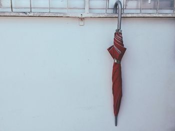 Close-up of umbrella hanging on wall