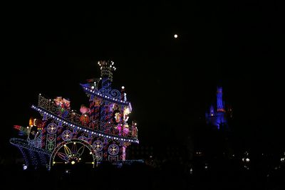 Illuminated city against sky at night