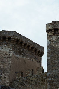 Low angle view of old ruin building against sky