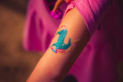 Midsection of woman wearing multi colored hand