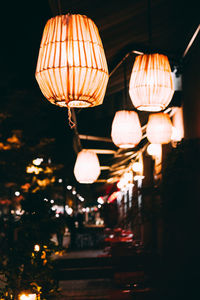 Low angle view of illuminated lanterns hanging at night