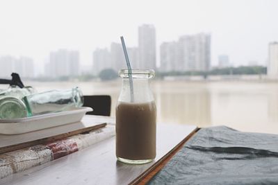 Close-up of drink on table against sky