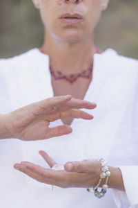 Female crystal healing therapist meditating, manifesting abundance with white selenite crystal